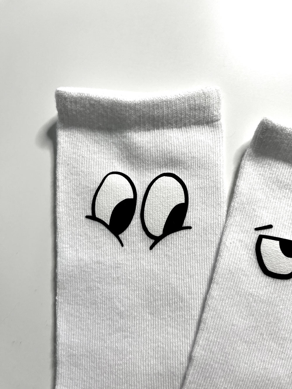 White socks with cute eyes DTF pressed onto them