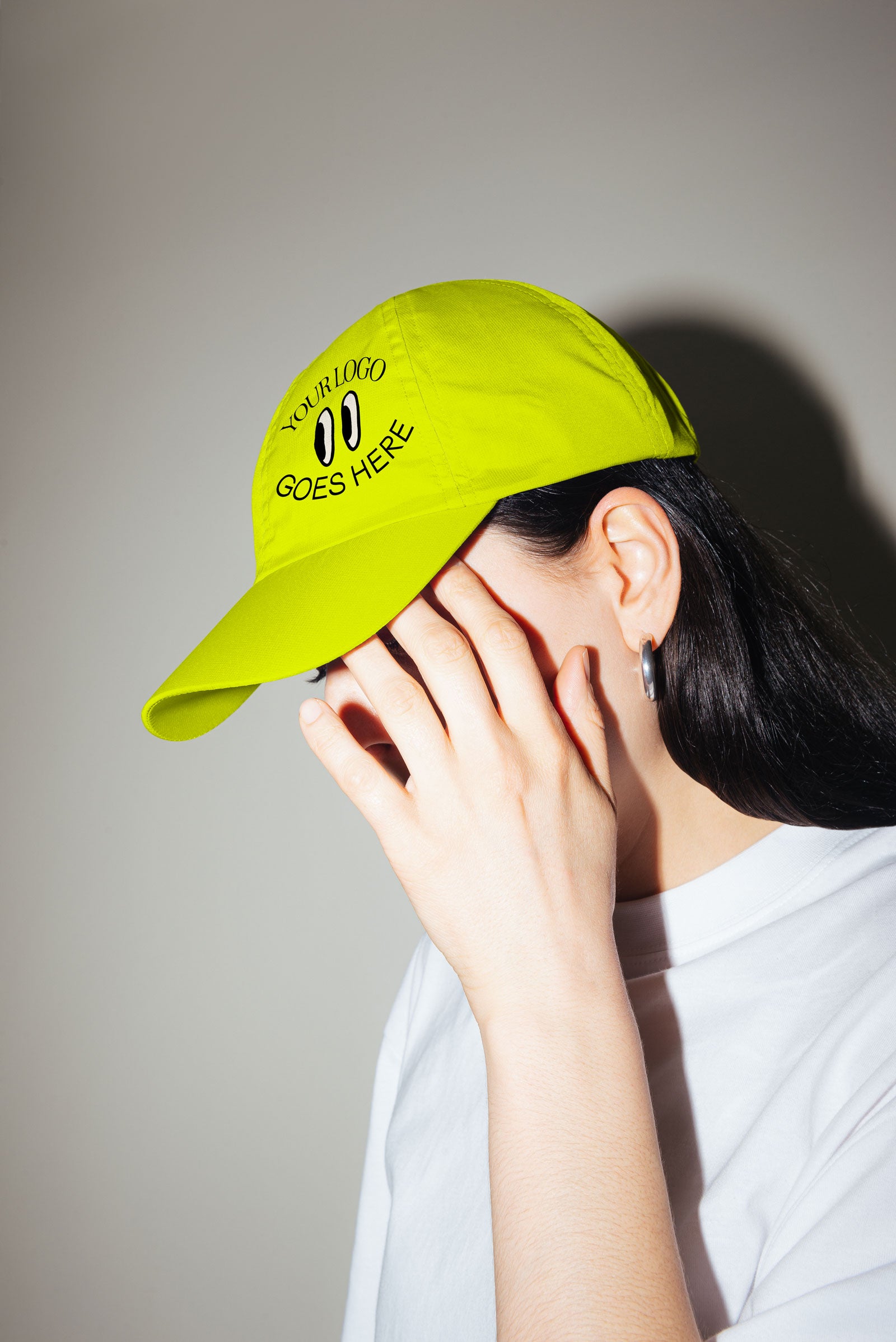 "Your logo goes here" printed using DTF transfer onto a bright yellow hat